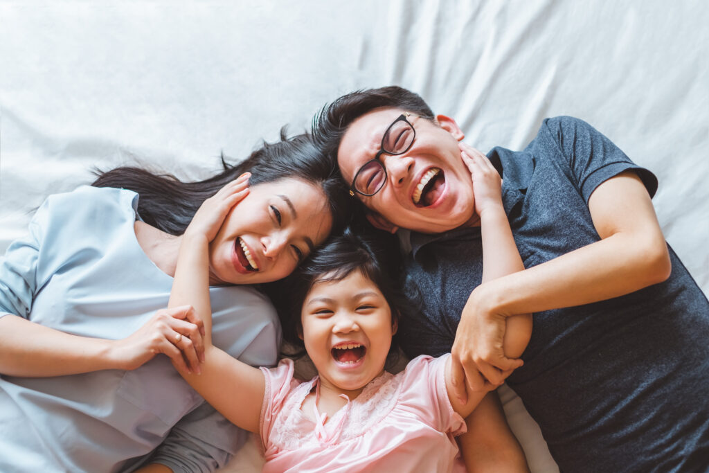 Parents and child smiling together