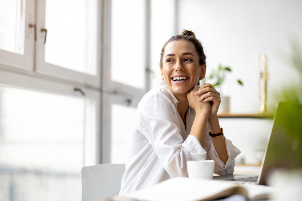 Woman smiling at a table
